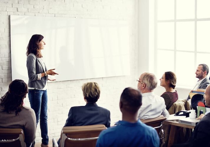 woman speaking to employees about addiction recovery